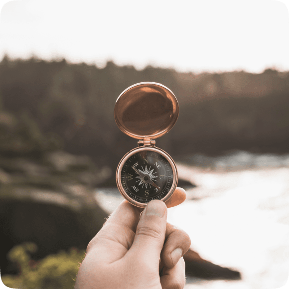 A hand holding a compass — finding your way through mental wellness
